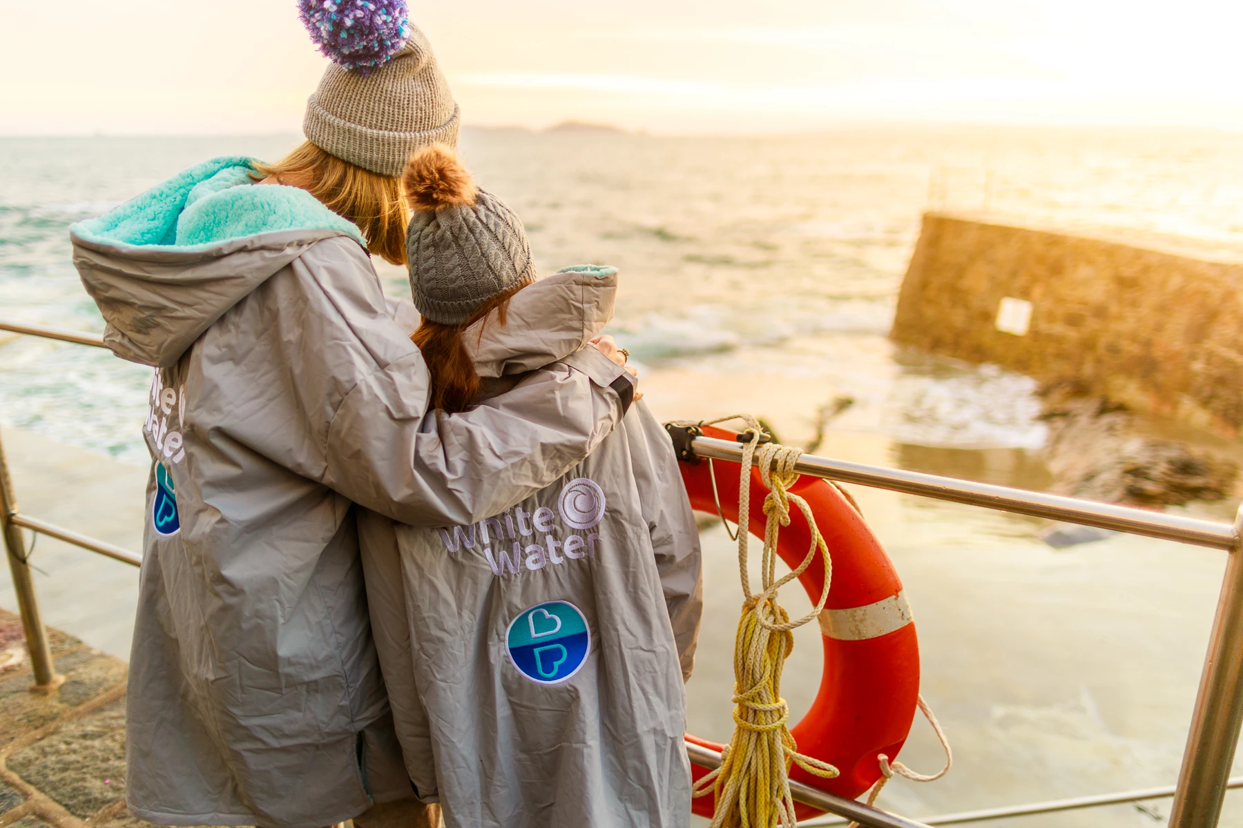 Colour photo of two people wearing hats
