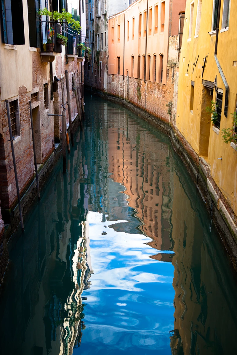 Colour photo of a canal between two buildings