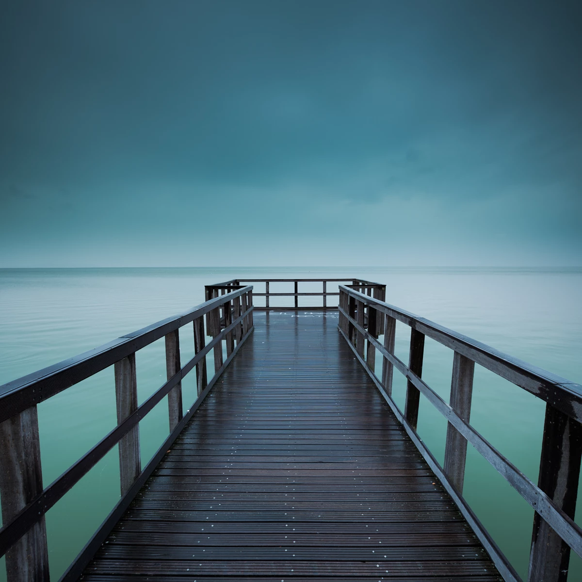 Colour photo of a wooden walkway over water
