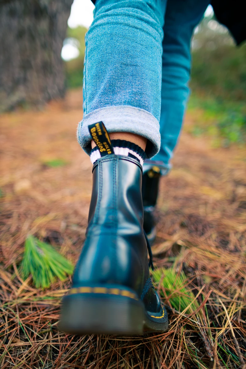 Colour photo of a person's feet wearing boots