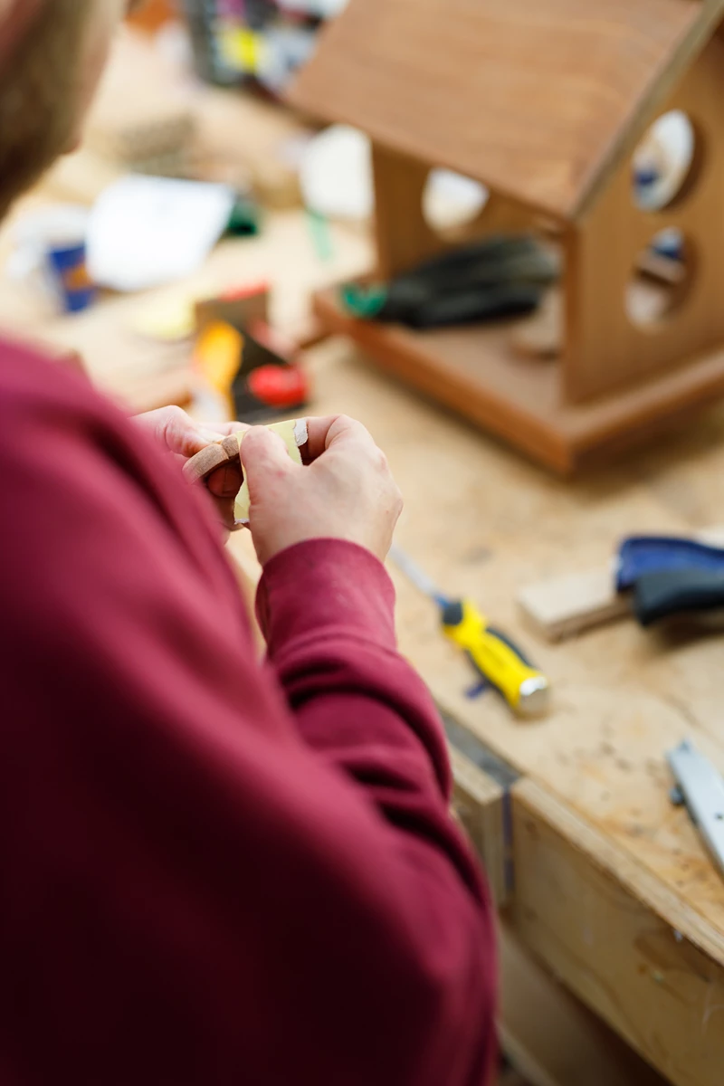 Colour photo of a person holding a small object