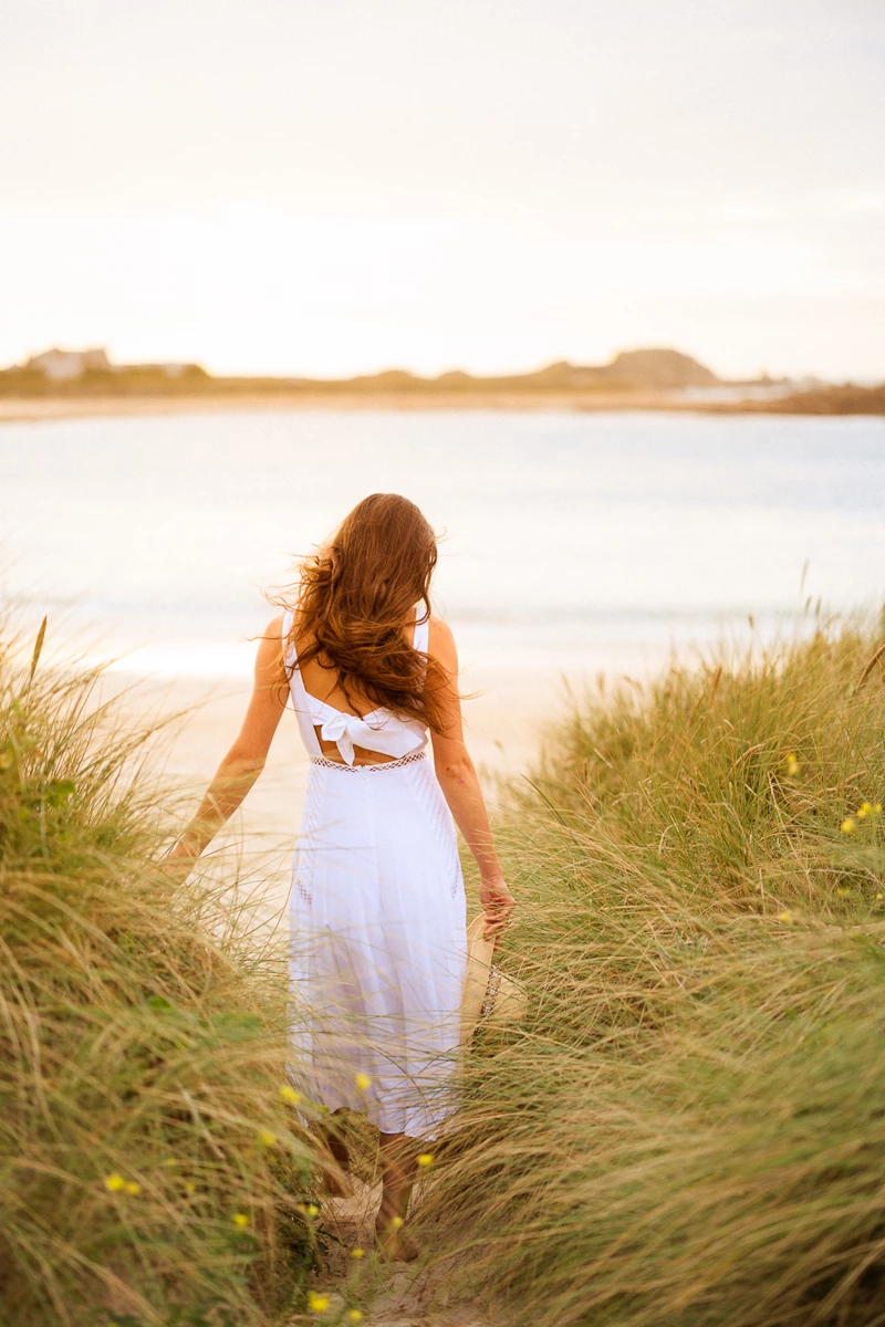 Colour photo of a person walking through tall grass