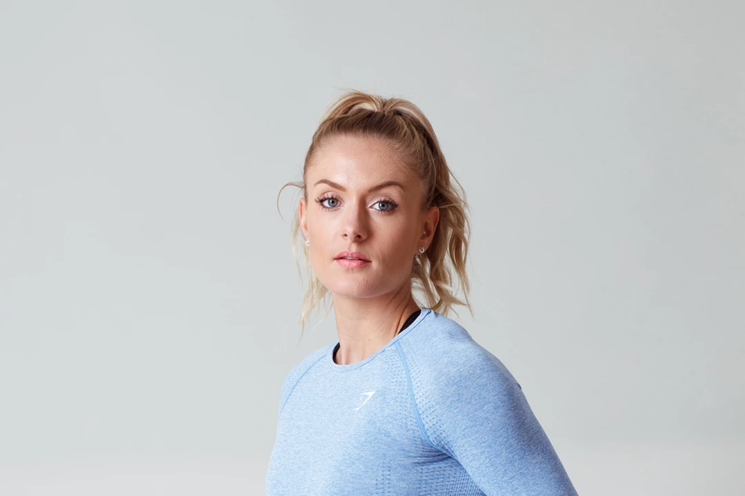 Studio lifestyle photo of a woman in gym clothing