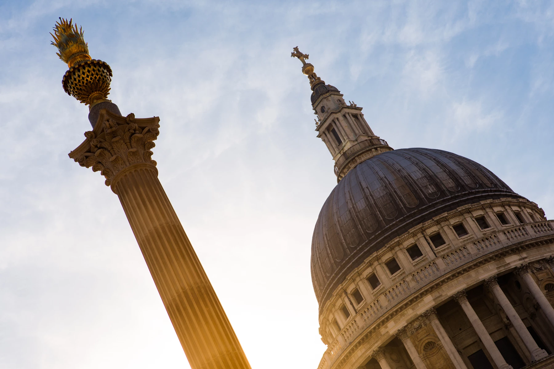 Colour photo of a tall tower with a gold statue on top