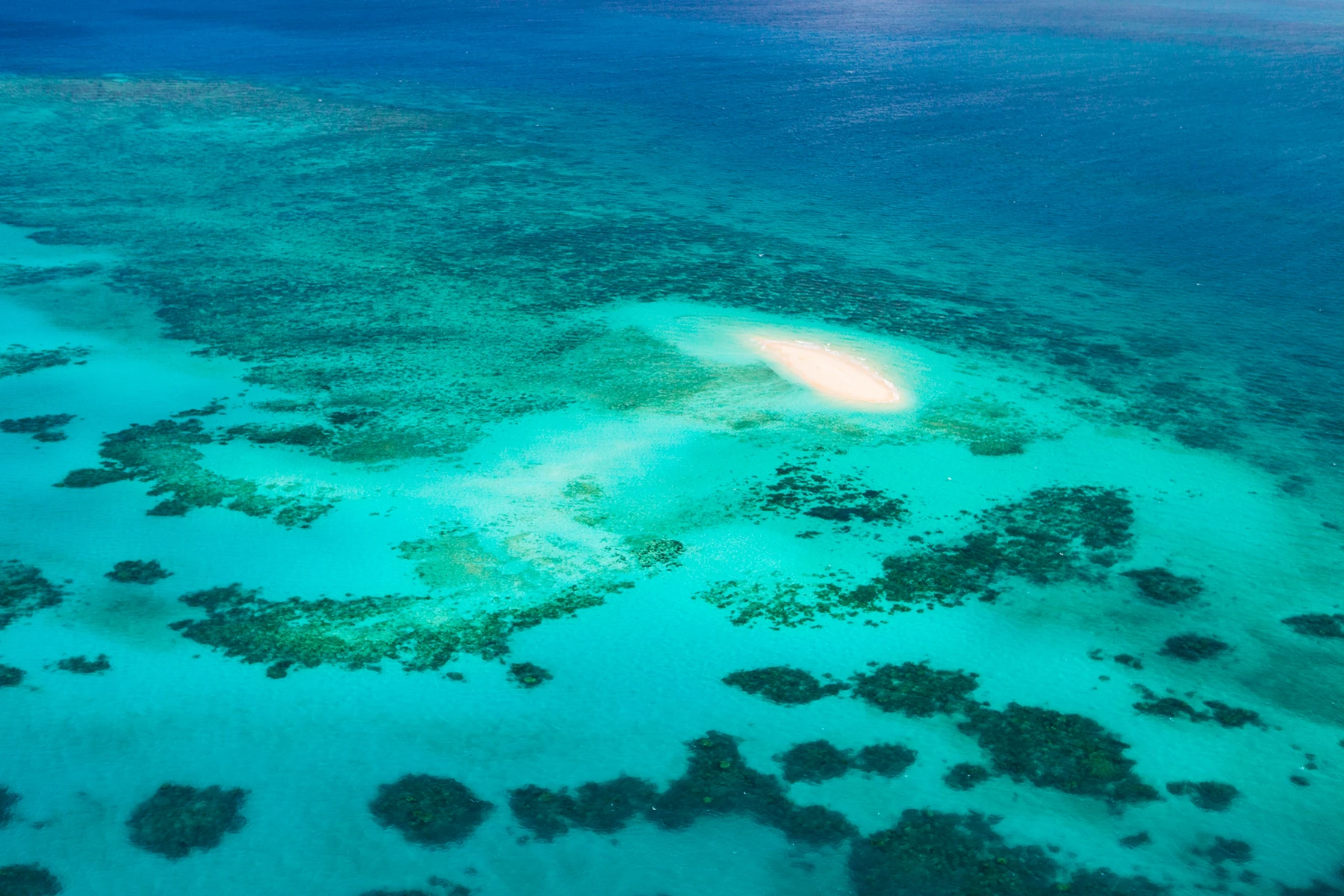 Colour photo of a bright light in the sky above a beach