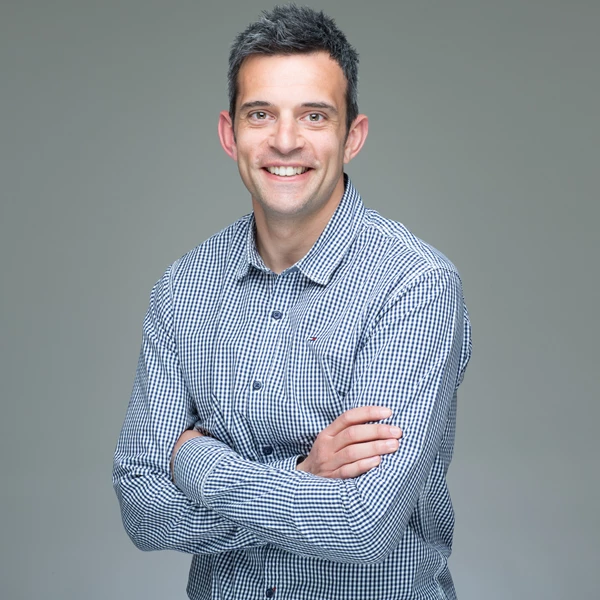 Corporate portrait head shot of man against gradient grey background