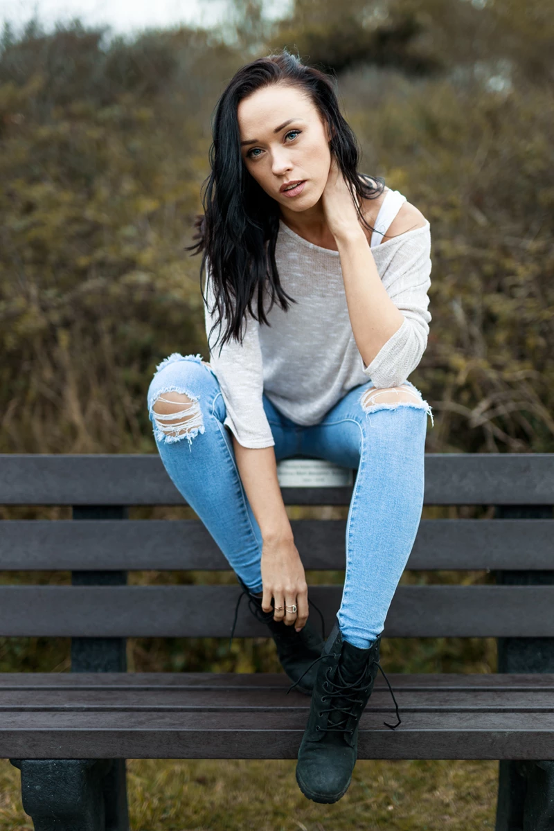 Lifestyle photo of woman sitting on park bench