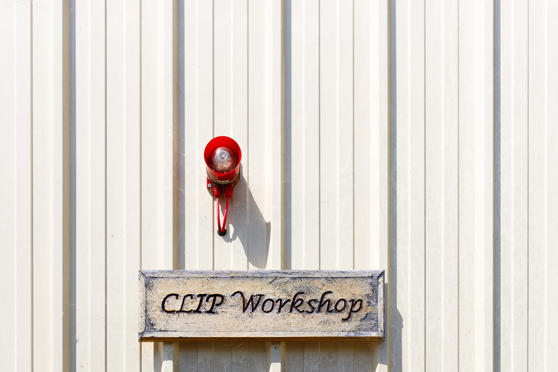 Colour photo of a red fire hydrant on a sign