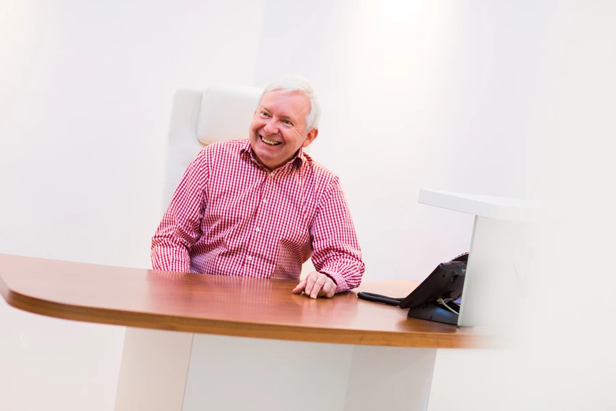 Corporate portrait head shot of man sitting at a desk