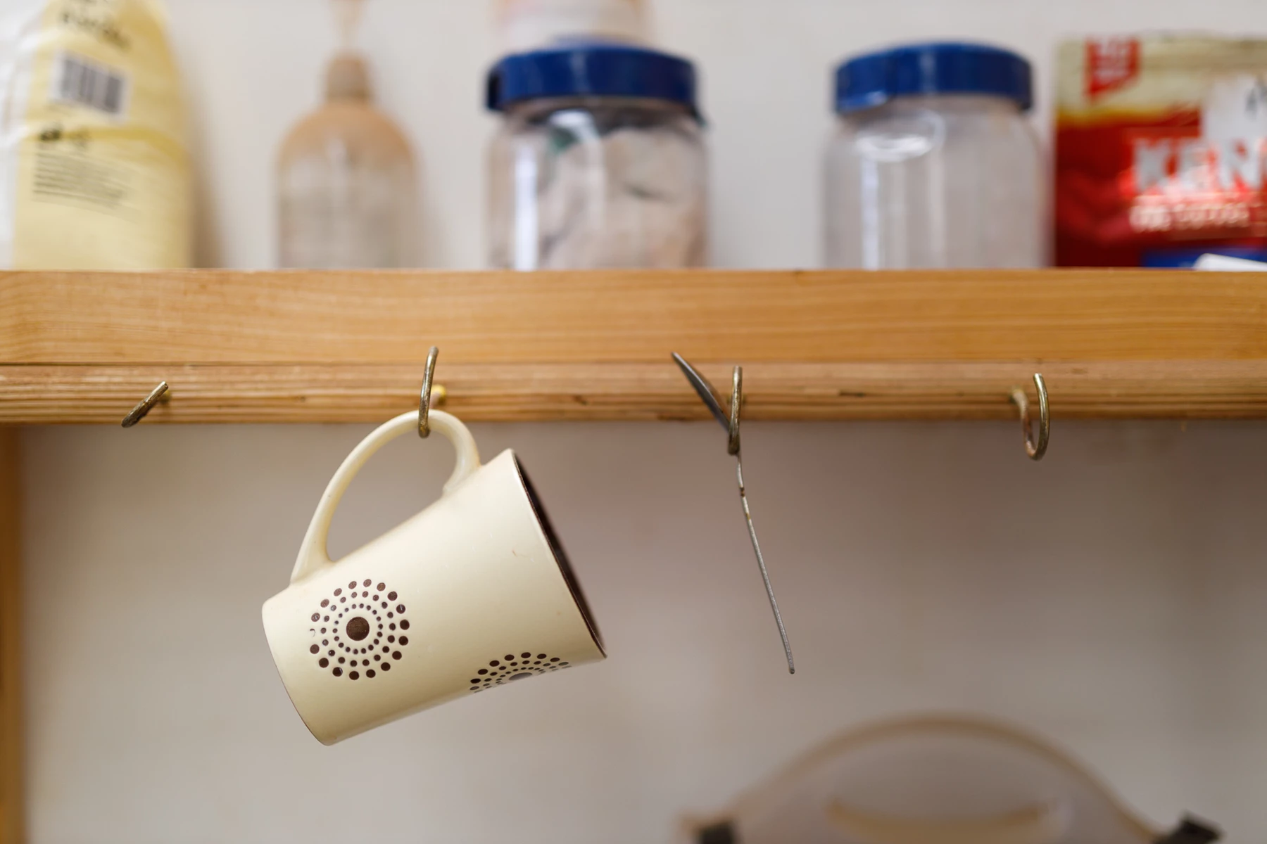 Colour photo of a white shelf with objects on it