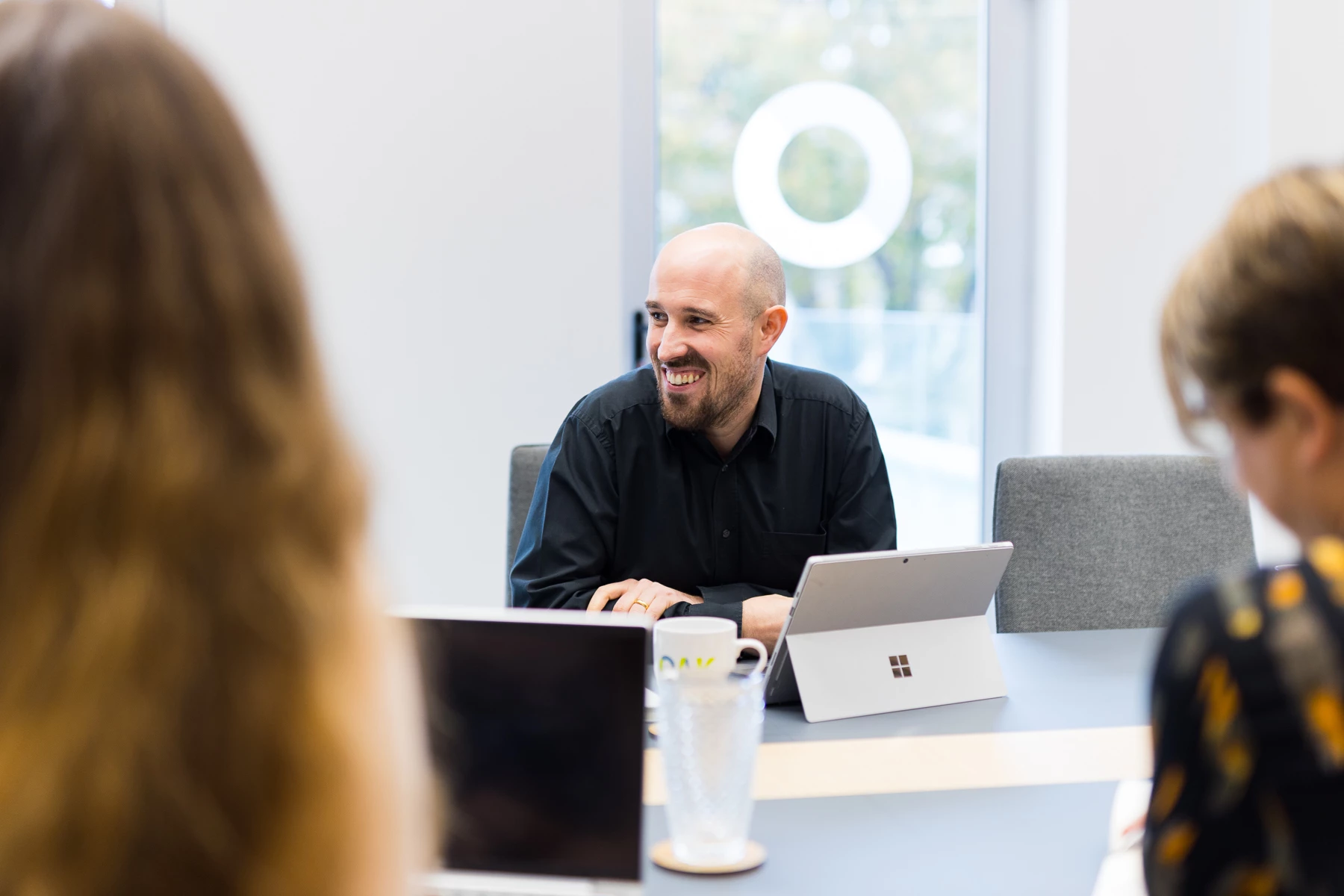 Colour photo of a person talking to a group of people