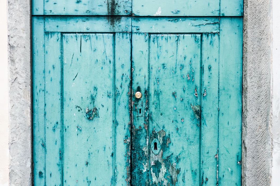 Colour photo of a blue door with a window