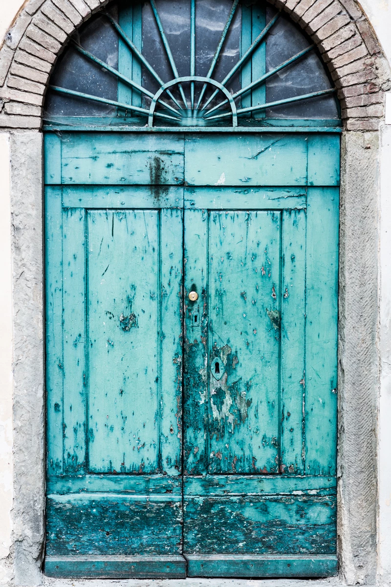 Colour photo of a blue door with a window