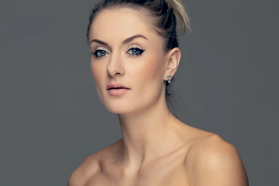 Studio beauty photo of woman against grey background