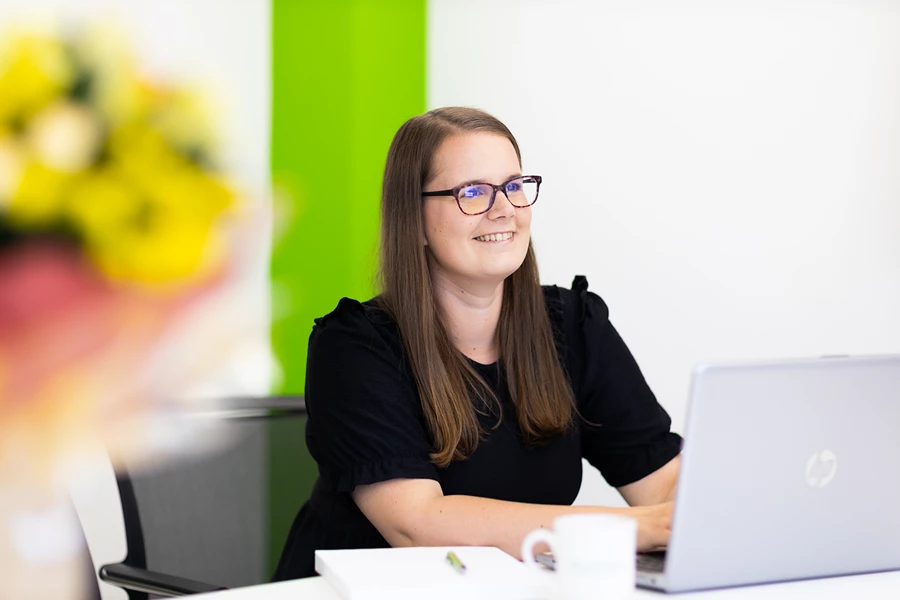 Colour photo of a person sitting at a table