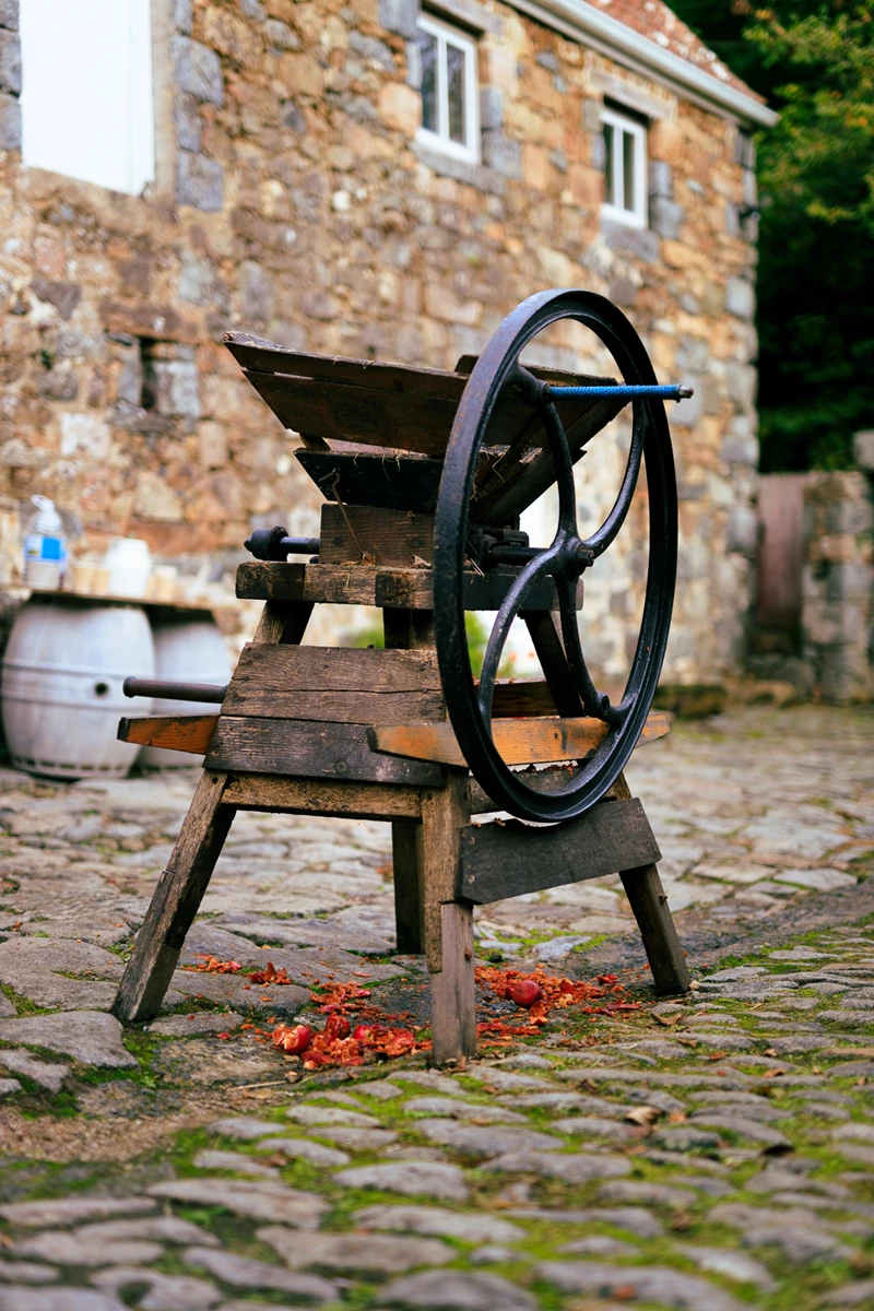 Colour photo of a wooden bench in front of a stone building