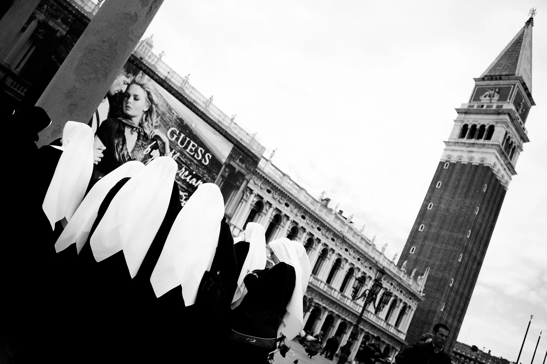 Black & white photo of a group of nuns in a square