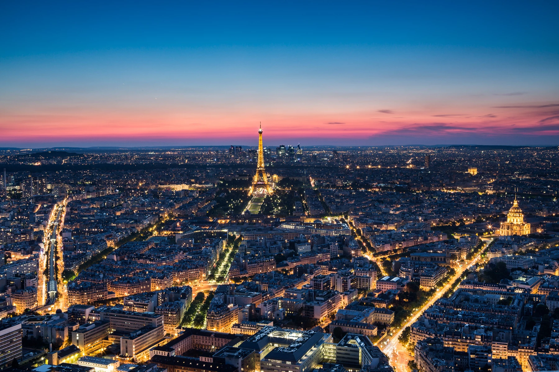 Travel landscape photo of Eifel Tower and Paris skyline at dusk with sunset sky