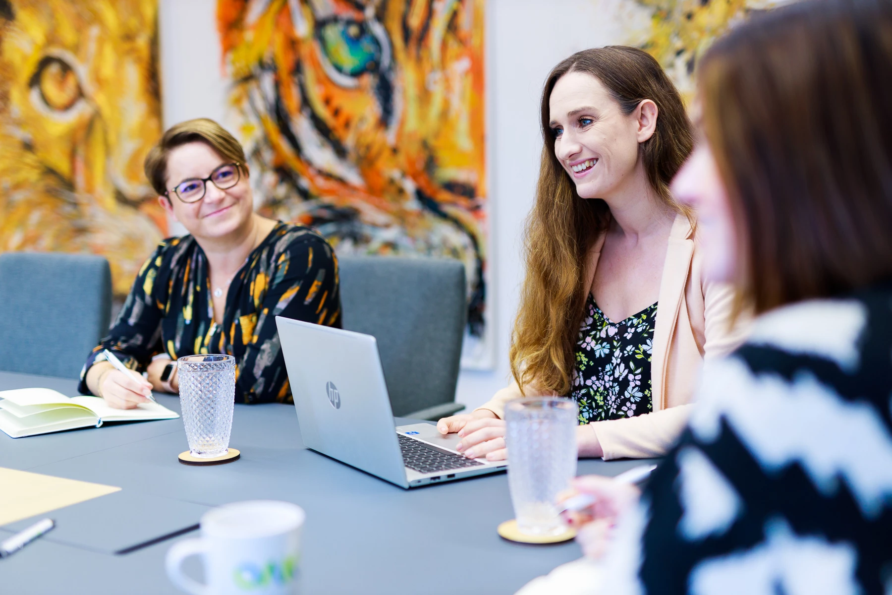 Colour photo of a few women sitting at a table