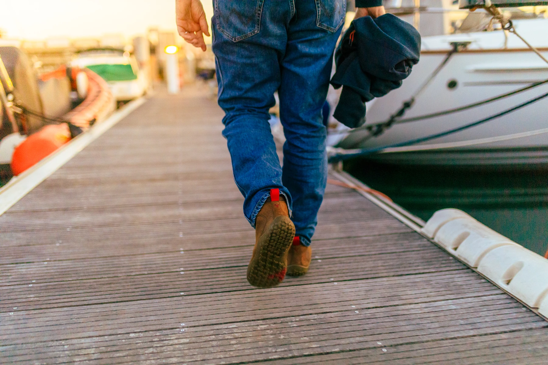 Colour photo of a person walking on a dock