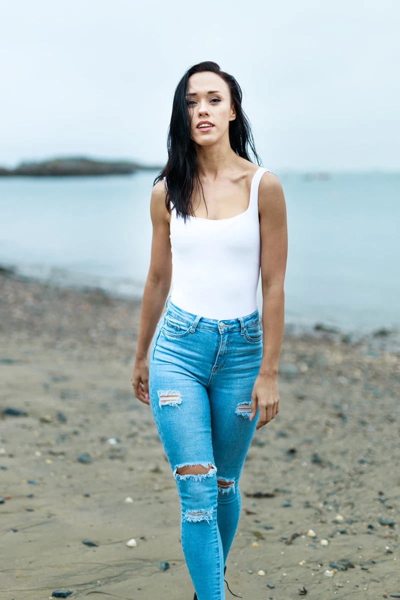 Lifestyle photo of woman walking on beach