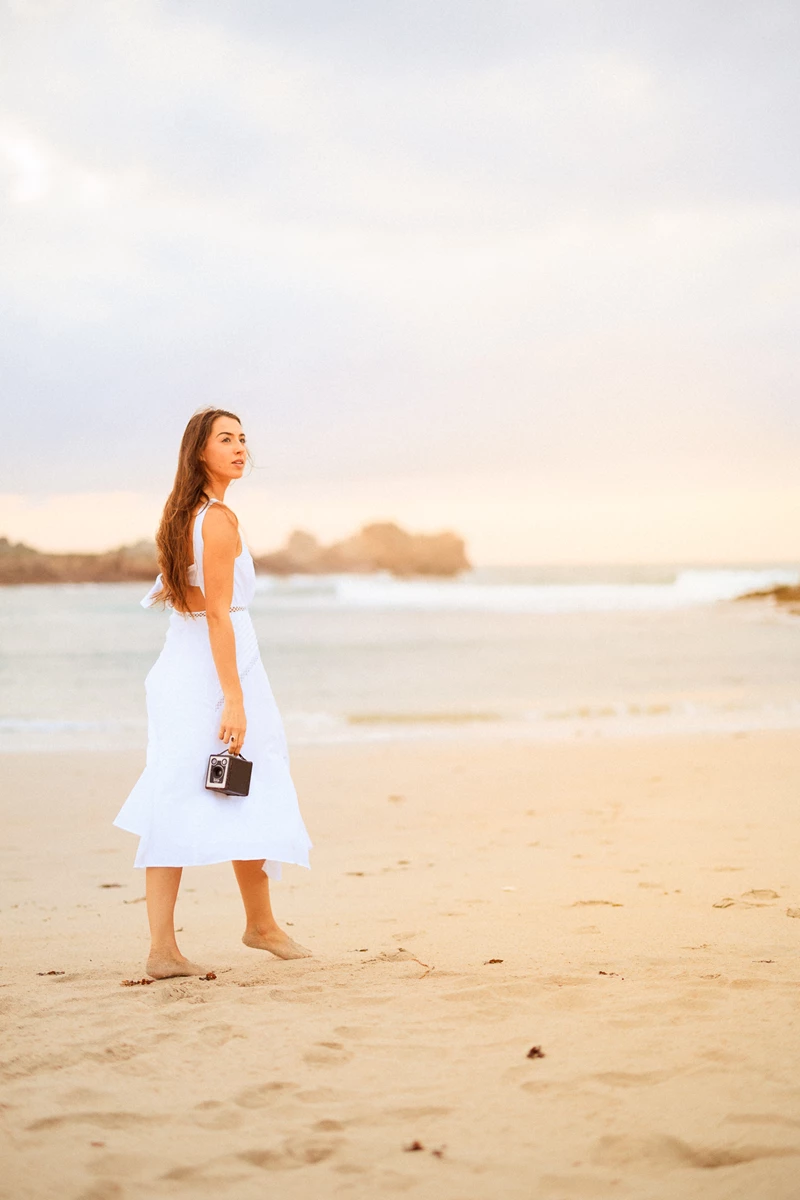 Colour photo of a person in a dress on a beach