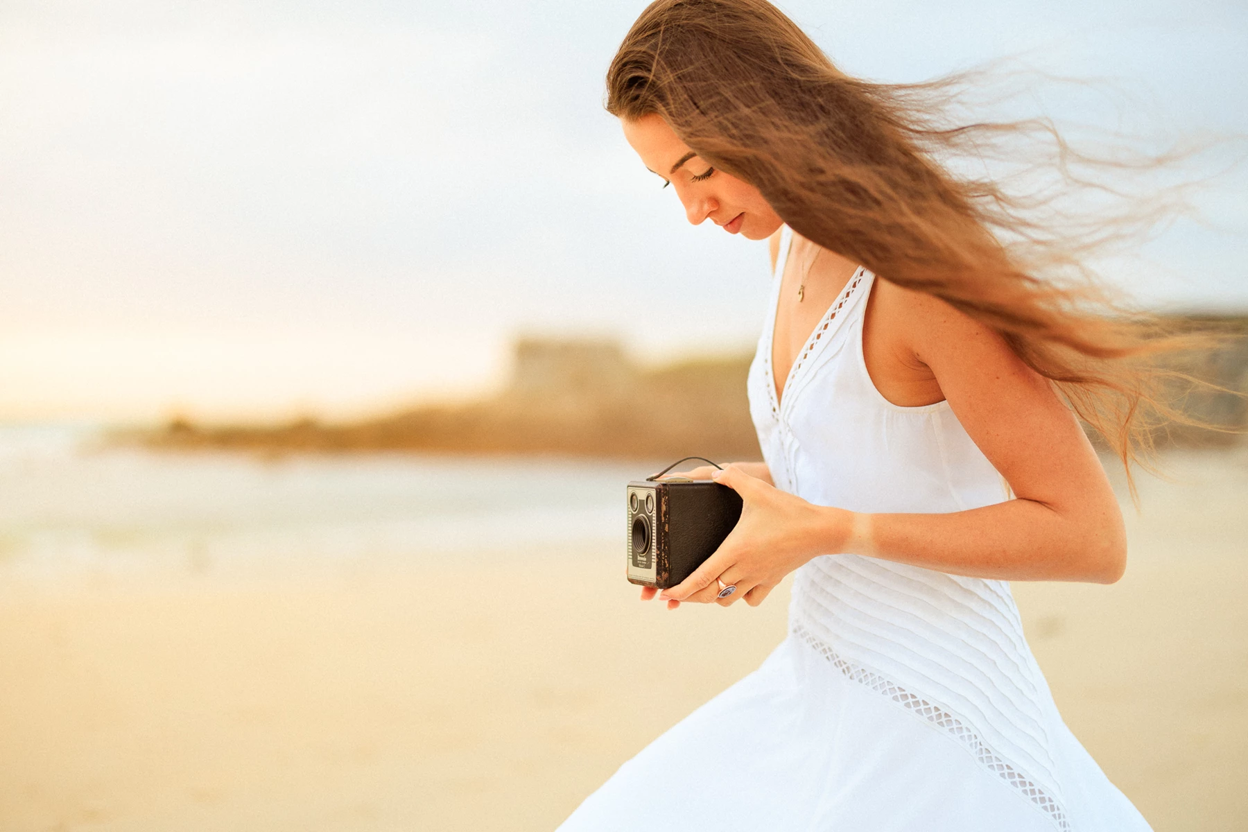 Colour photo of a woman holding a phone