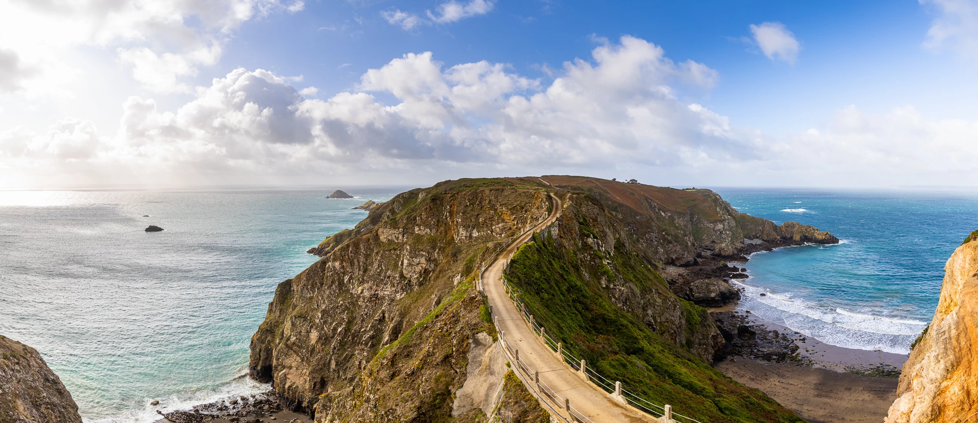 Colour photo of a rocky cliff next to the ocean