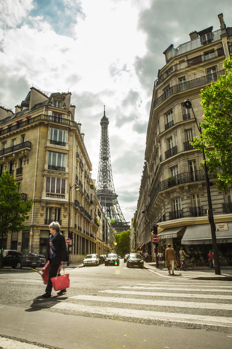Colour photo of a person crossing a street