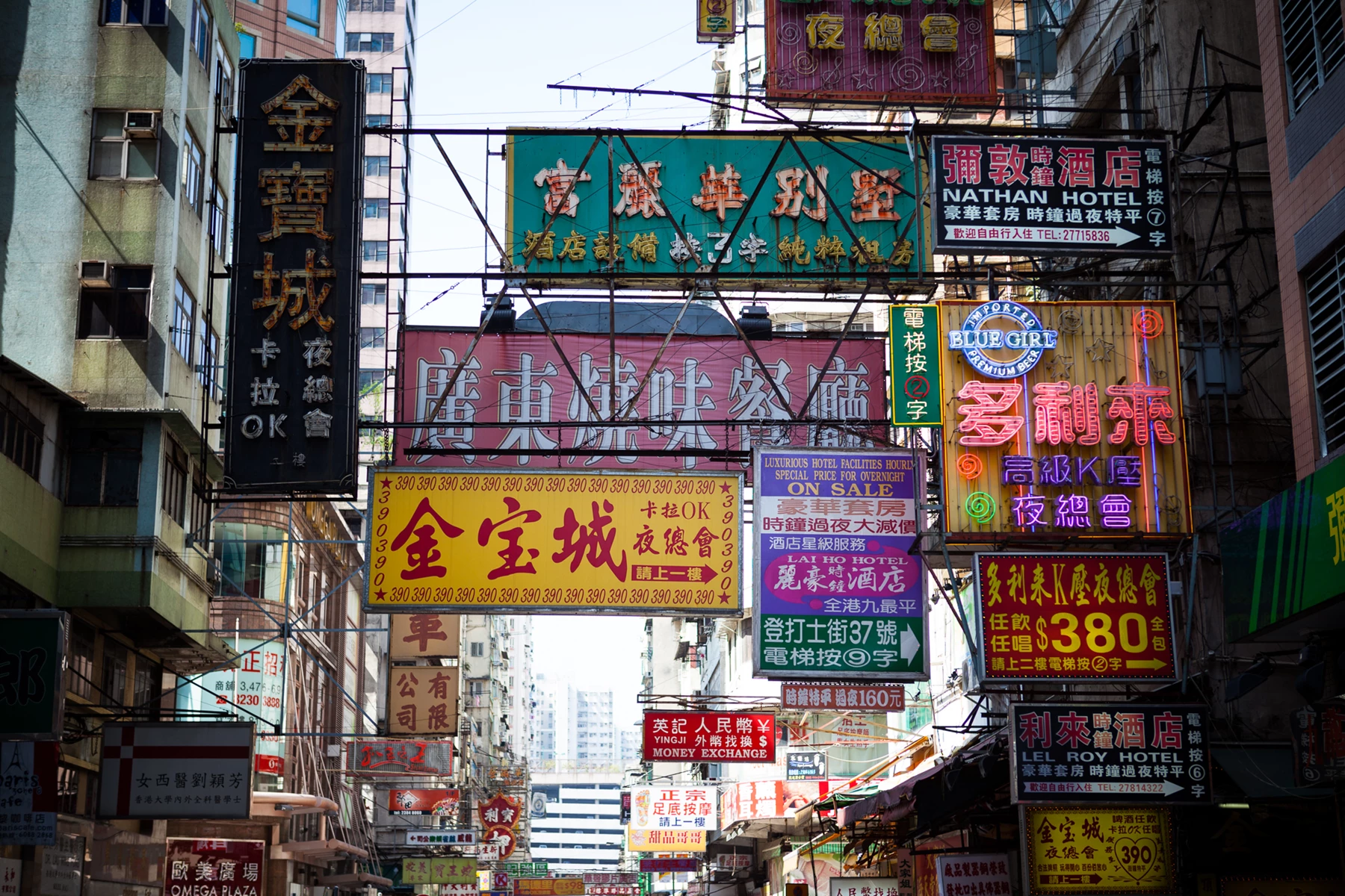Colour photo of a city street is filled with signs