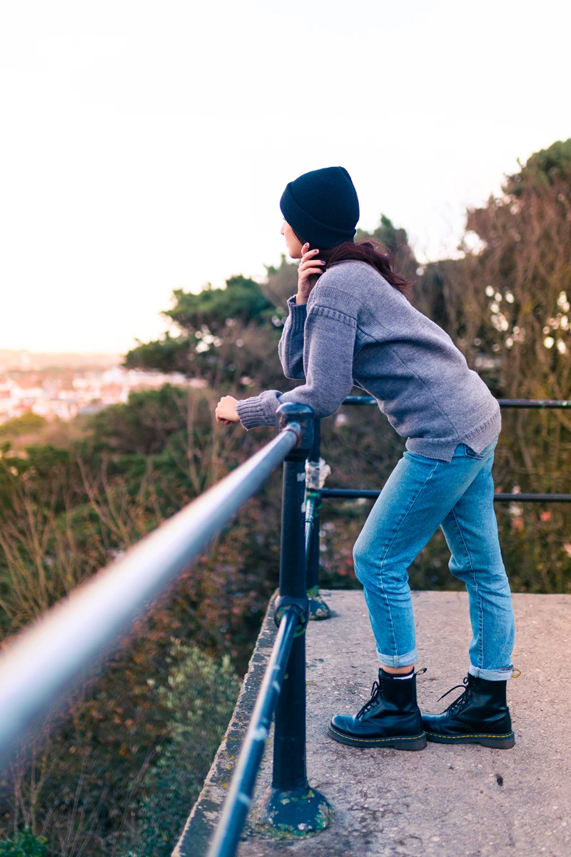 Colour photo of a man leaning on a rail