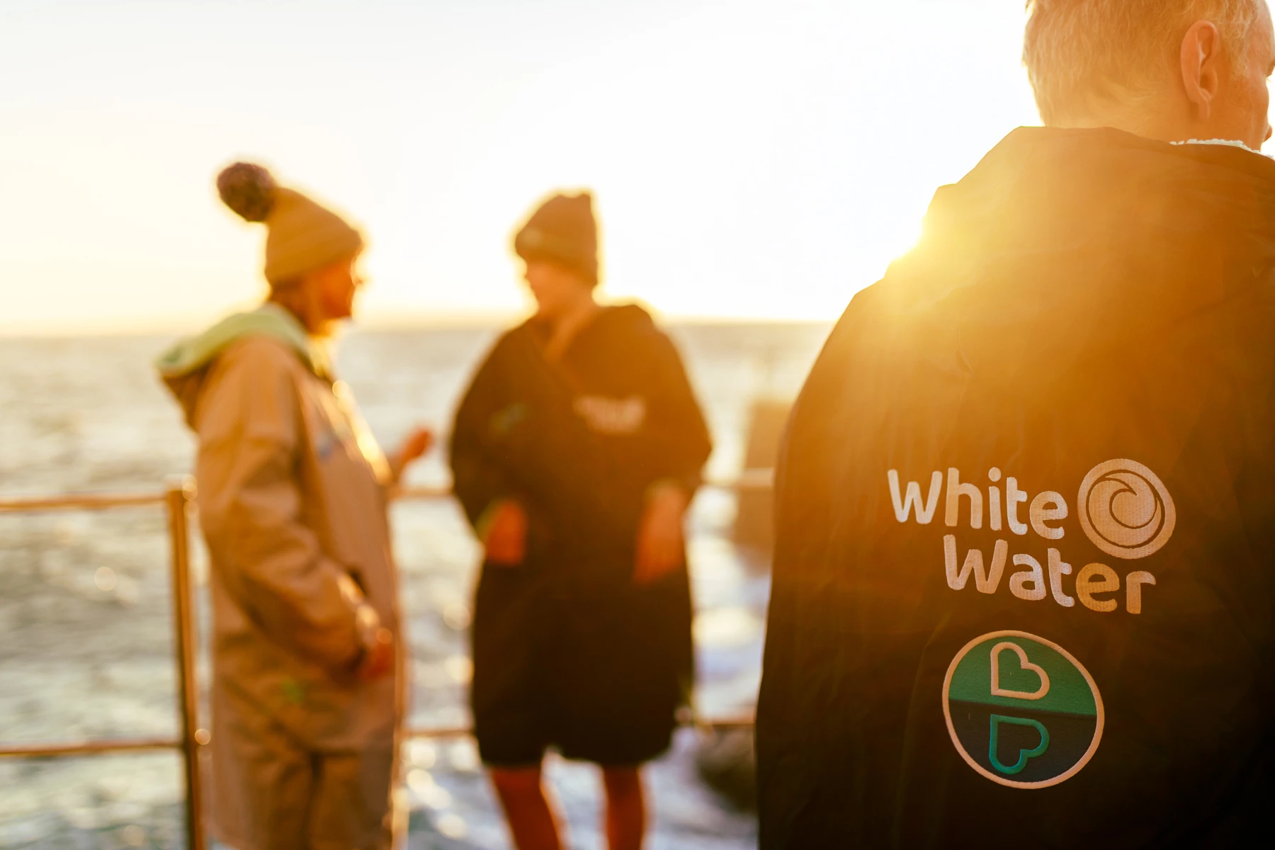 Colour photo of a group of men standing on a dock