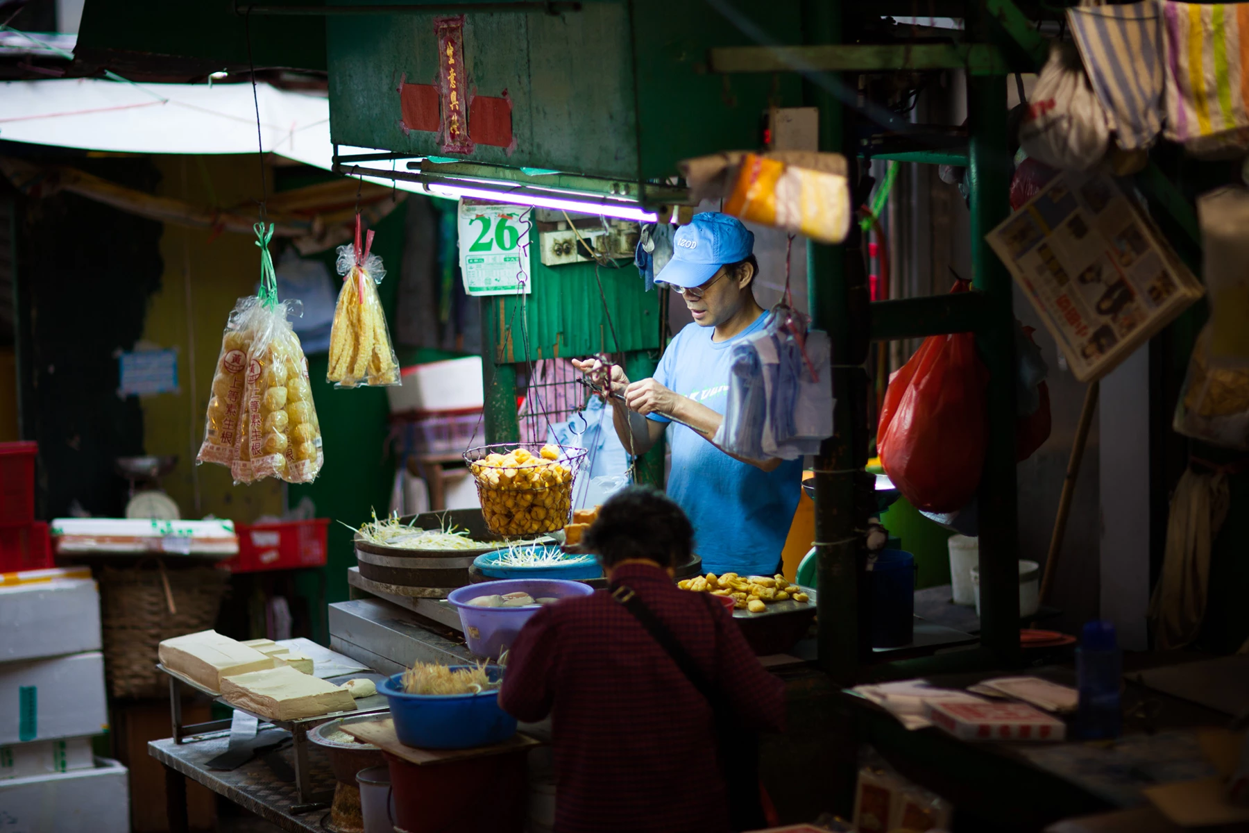 Colour photo of a person selling food in a market