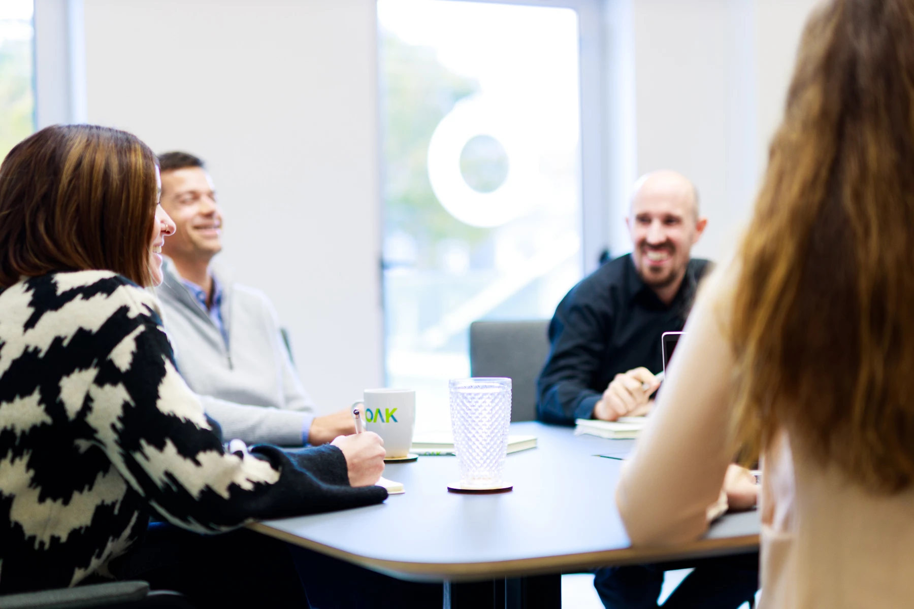 Colour photo of a group of people sitting around a table