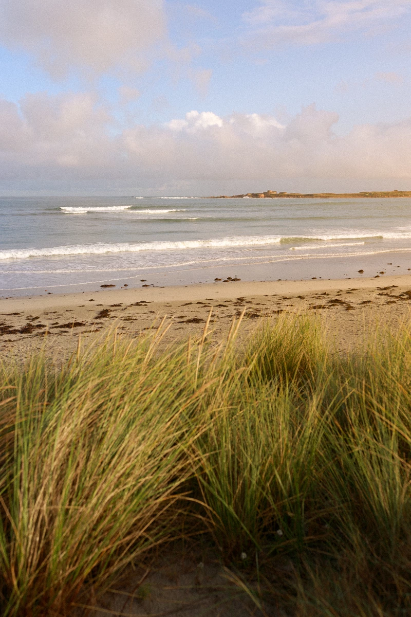 Colour photo of a beach with waves crashing on it