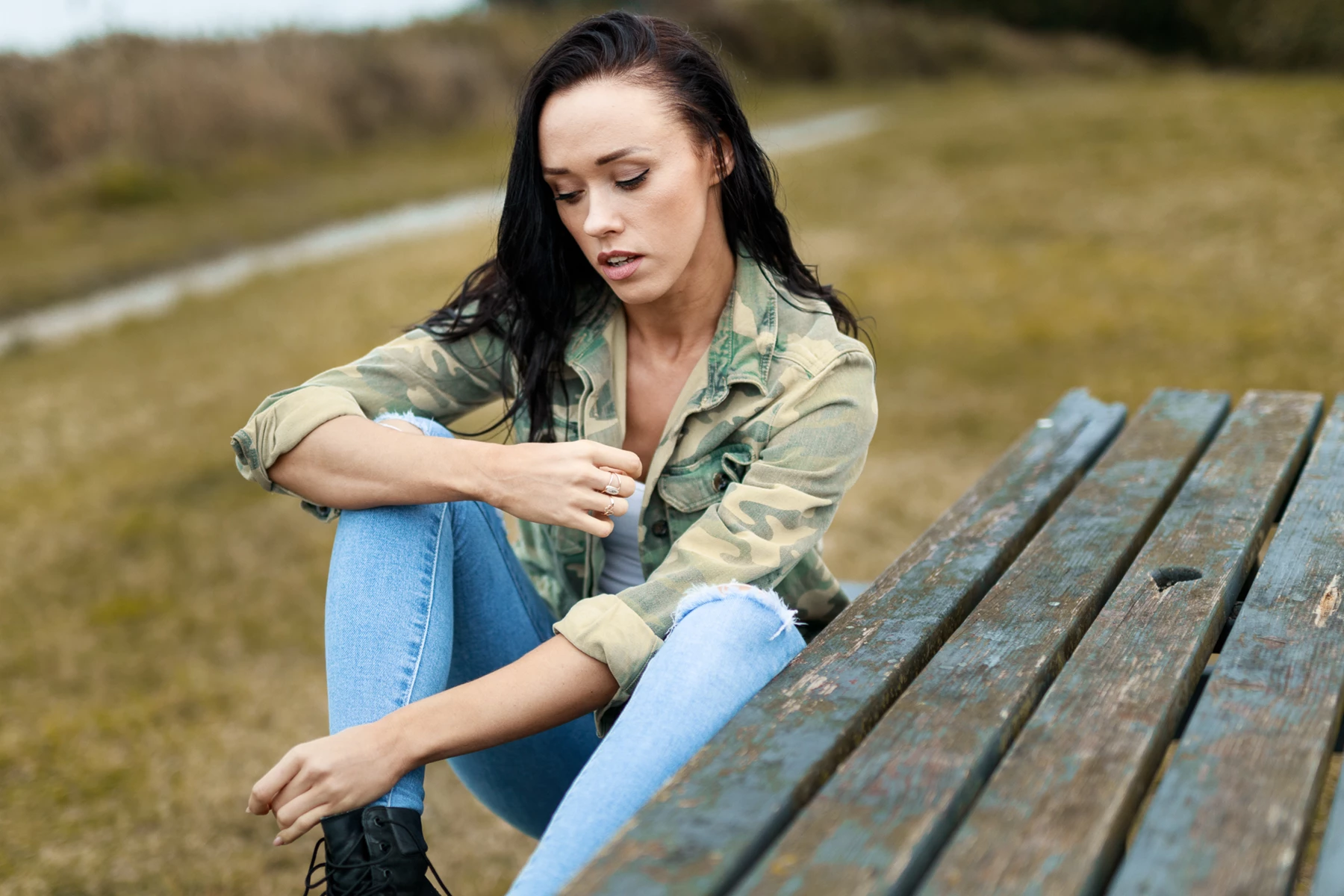 Lifestyle photo of woman sitting on picnic table