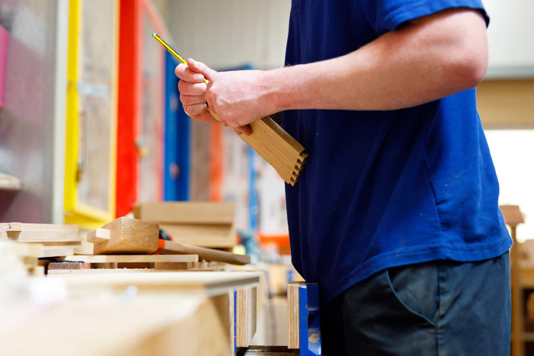Colour photo of a man holding a pencil