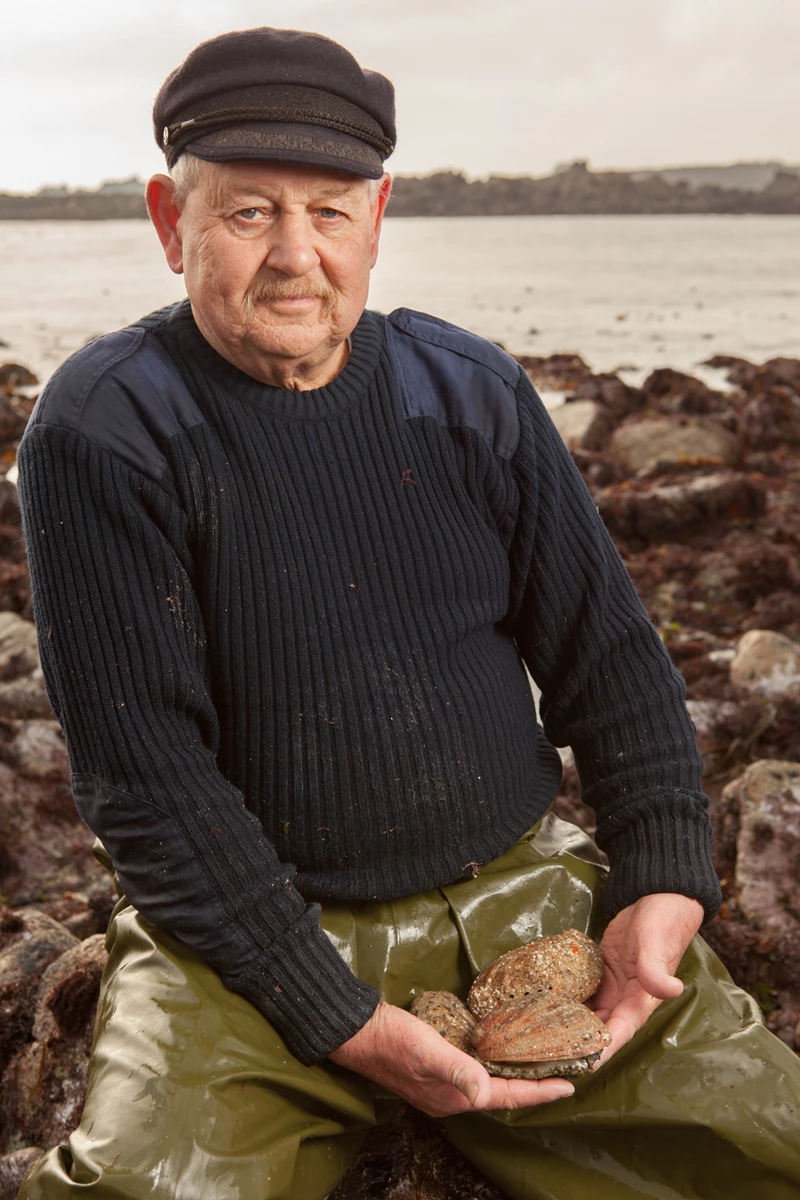 Colour photo of a man holding a turtle