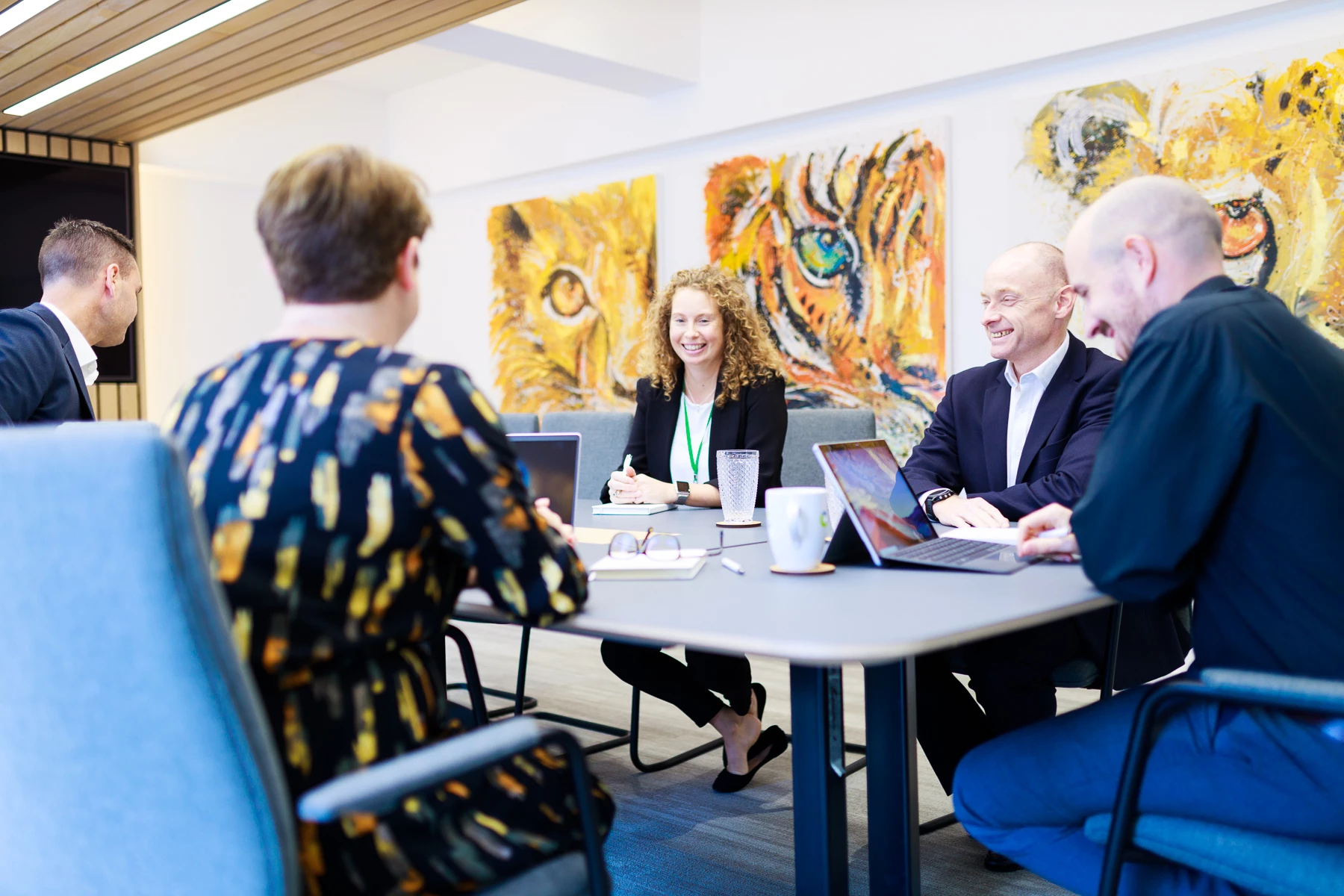 Colour photo of a group of people sitting around a table