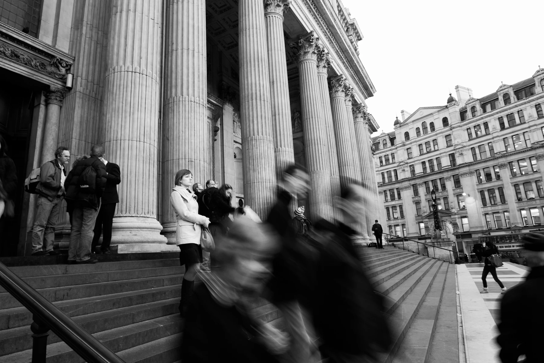 Black & white photo of a group of people standing on stairs