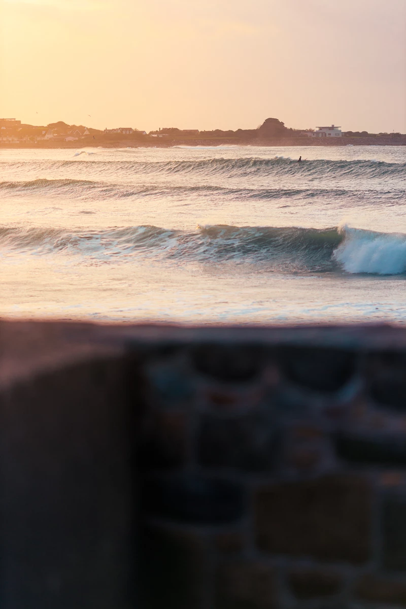 Colour photo of waves crashing on a beach