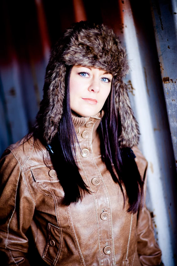 Fashion portrait of woman in leather jacket and furry hat