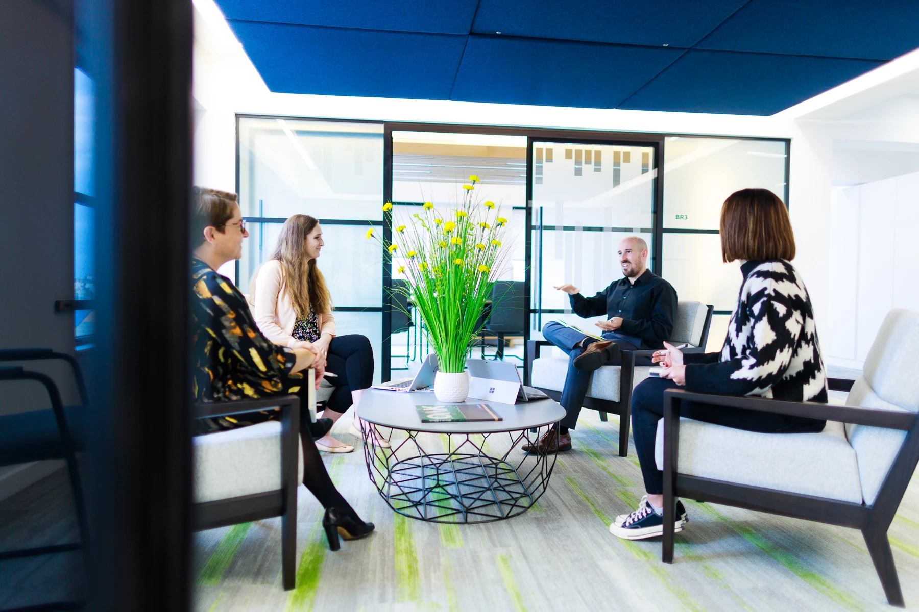 Colour photo of a group of people sitting in chairs