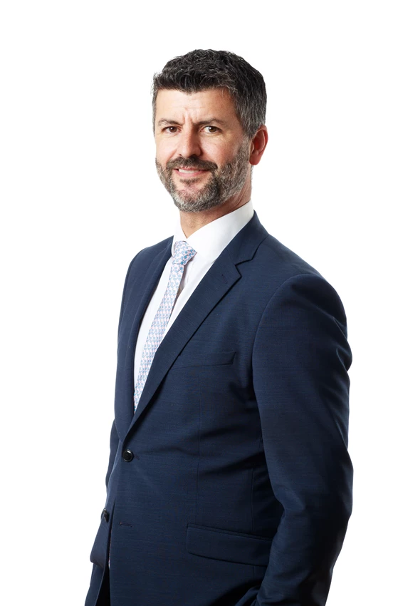 Colour photo of Sean Devine in a suit