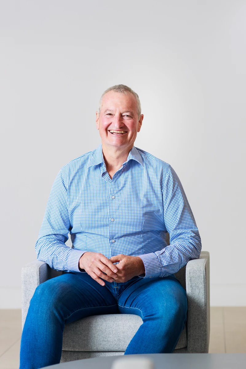 Colour photo of a man sitting in a chair