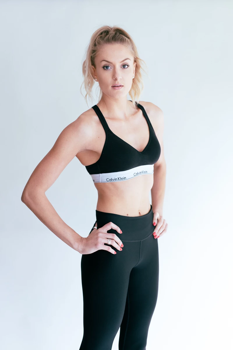 Studio lifestyle photo of a woman in gym clothing