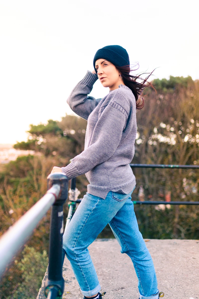 Colour photo of a person leaning on a railing