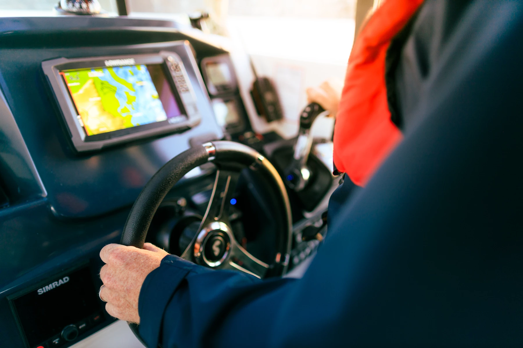Colour photo of a person driving a car