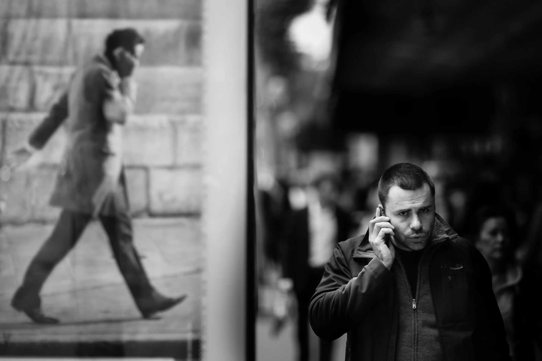 Black & white photo of a person talking on a cell phone