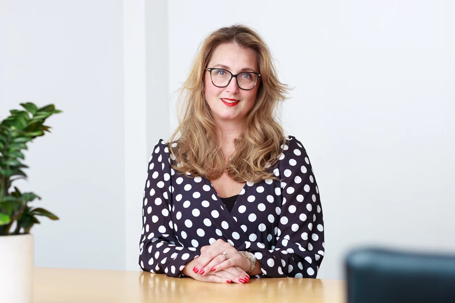 Colour photo of a person sitting at a table